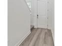 Bright entryway with wood-look floors and a white front door at 1793 Archer Dr, Minneola, FL 34715