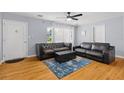 Cozy living room with hardwood floors, comfortable seating, and natural light streaming through the windows at 2072 Grandview S Ave, Sanford, FL 32771