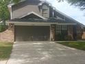 Charming two-story home with a two-car garage, brick, and gray vinyl siding at 2181 Wekiwa Oaks Dr, Apopka, FL 32703