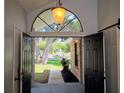 Open foyer with view of large tree in front yard through arched window above the front door at 2181 Wekiwa Oaks Dr, Apopka, FL 32703