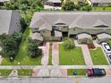 Aerial view of two-story homes with well-kept lawns and brick driveways at 2311 Chatham Place Dr, Orlando, FL 32824