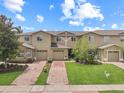 Charming two-story home with well-kept lawn and brick driveway at 2311 Chatham Place Dr, Orlando, FL 32824