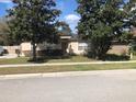 Lovely single-story home with mature trees, a well-kept lawn, and a welcoming entrance at 2555 Palmetto Ridge Cir, Apopka, FL 32712
