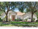 Beautiful home with a well-kept lawn, complemented by mature trees at 2674 Spicebush Loop, Apopka, FL 32712