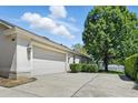 Spacious two-car garage with an expansive driveway and manicured landscaping at 2674 Spicebush Loop, Apopka, FL 32712