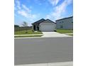 Cozy single-story home with a two-car garage and manicured front lawn at 2707 Virginia Pine Nw Dr, Bartow, FL 33830