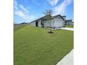 Single-story home featuring a well-maintained lawn and a two-car garage at 2707 Virginia Pine Nw Dr, Bartow, FL 33830