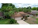Aerial view of the property with mature trees, a driveway, and a well-kept yard at 2715 Wekiva Meadows Ct, Apopka, FL 32712
