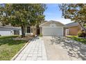 Charming one story home with a two car garage and beautiful mature trees at 2933 Birmingham Blvd, Orlando, FL 32829