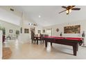 Spacious living room with a billiards table, dining area, and tile flooring at 3018 Bransbury Ct, Kissimmee, FL 34747