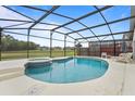 Screened-in pool area with a spa, lounge chairs, and views of the backyard at 3018 Bransbury Ct, Kissimmee, FL 34747