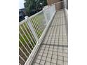 A spacious back deck with white railings and a view of the green lawn at 3057 Aaron Burr Ave # 2, Winter Park, FL 32792