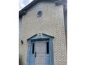 The entrance to the home features brick siding, a round window, and blue trim around the door frame at 3057 Aaron Burr Ave # 2, Winter Park, FL 32792