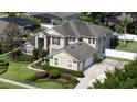 Spacious home featuring a well-manicured lawn, mature trees, and an attached two-car garage at 325 Green Ash Ln, Sanford, FL 32771