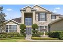 Attractive two-story home featuring stone accents, large windows, and well-maintained front yard with fountain at 325 Green Ash Ln, Sanford, FL 32771