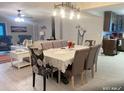 Open-concept dining room with seating for six, view to living room and adjacent kitchen at 400 Palm Ave, Ormond Beach, FL 32174