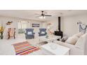 Comfortable living room with bright decor, ceiling fan, fireplace and seating area at 400 Palm Ave, Ormond Beach, FL 32174