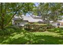 Attractive home exterior with a well-manicured lawn and mature trees providing ample shade at 4030 Cool Water Ct, Winter Park, FL 32792
