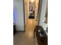 Bright hallway with neutral walls, decorative mirror, and hardwood flooring at 4820 Kathy Jo Ter, Orlando, FL 32808