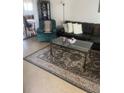 Inviting living room featuring a comfortable leather sofa, a stylish rug, and modern decor at 4820 Kathy Jo Ter, Orlando, FL 32808