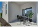 Cozy outdoor patio featuring a metal table with four chairs and decorative potted plants for relaxation and enjoyment at 490 Belmond Dr, Debary, FL 32713