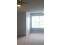 Bright living room with ceiling fan and multiple windows, flooding the space with natural light and creating an airy feel at 5160 Conroy Rd # 1437, Orlando, FL 32811