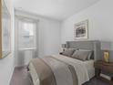 Cozy bedroom with plush carpet, large window, and tastefully decorated in neutral tones at 558 Orient Ave, Debary, FL 32713
