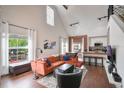 Spacious living room featuring a large comfortable orange sofa and high ceilings with bright natural light at 6001 Westgate Dr # 2124, Orlando, FL 32835