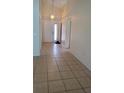 Inviting foyer with tile flooring and a stylish light fixture at 602 Hillcrest Dr, Davenport, FL 33897