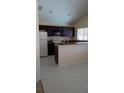 Well-lit kitchen with dark cabinetry, stainless steel microwave, and laminate countertop at 602 Hillcrest Dr, Davenport, FL 33897