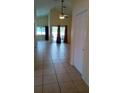 Open-concept living room with sliding glass doors and neutral tile floors at 602 Hillcrest Dr, Davenport, FL 33897