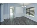 Dining room boasts hardwood floors, decorative trim, and large windows providing natural light at 6160 Froggatt St, Orlando, FL 32835