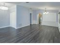 Open-concept living area featuring hardwood floors, archways, and recessed lighting at 6160 Froggatt St, Orlando, FL 32835