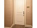 View of the unit's front door, number 2508, featuring neutral-toned wall coverings and a glimpse of the carpet at 630 Vassar St # 2508, Orlando, FL 32804
