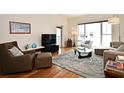 Cozy living room featuring modern furnishings, a large window, and a stylish rug on wood floors at 630 Vassar St # 2508, Orlando, FL 32804