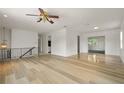 Spacious living room with light hardwood floors, white walls, and a ceiling fan at 6416 Jackwood Ct, Orlando, FL 32818