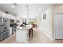 Spacious kitchen with stainless steel appliances, a large island, and an open floor plan at 1028 Salamanca Pl, Davenport, FL 33837