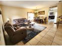 Inviting living room with comfortable seating, a decorative rug, and ample natural light at 10549 Cypress Trail Dr, Orlando, FL 32825