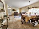 Open-concept living and dining area with tile floors and stylish furnishings at 10549 Cypress Trail Dr, Orlando, FL 32825