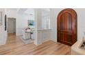 Bright dining area featuring wood floors, decorative molding, and a grand arched doorway at 11018 Lake Butler Blvd, Windermere, FL 34786