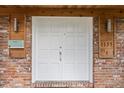 A welcoming double front door with brick surround, modern sconces, and a unique address display at 1135 Thunder Trl, Maitland, FL 32751