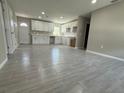 Open concept kitchen with white cabinets and light gray tile floors at 1139 Poppy Ave, Orlando, FL 32811