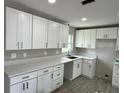 Newly renovated kitchen with modern white cabinets, light countertops, and recessed lighting fixtures at 1139 Poppy Ave, Orlando, FL 32811