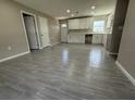 Open concept kitchen with white cabinets and light gray tile floors at 1139 Poppy Ave, Orlando, FL 32811