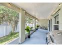 Relaxing screened patio with outdoor furniture, string lights, grill, and views of the lush backyard at 1221 N Brickell Dr, Deltona, FL 32725