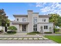 Striking two-story modern home featuring a stone accent wall and professionally landscaped front yard at 1820 Englewood Rd, Winter Park, FL 32789