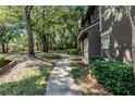 Tree covered walkway leading to a back door at 209 Villa Di Este Ter # 205, Lake Mary, FL 32746