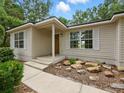 Inviting single-story home with a covered entry and manicured landscaping at 2193 County Road 204, Oxford, FL 34484