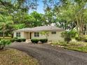 Inviting single-story home with a well-maintained lawn and a tree-lined yard at 2193 County Road 204, Oxford, FL 34484