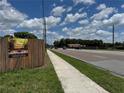Street view featuring a wide sidewalk and a neighboring Bedroom under a bright, sunny sky at 2223 Kilmer Ln, Apopka, FL 32703
